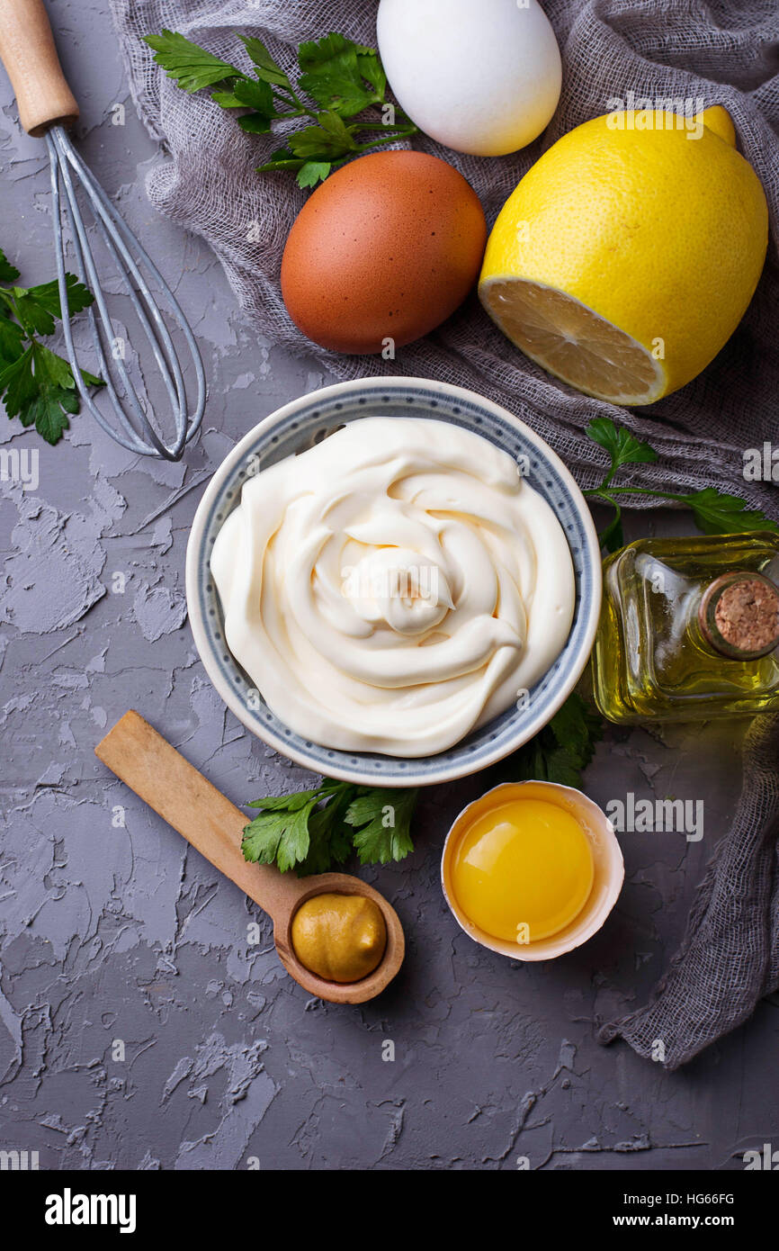 Homemade mayonnaise sauce and olive oil, eggs, mustard, lemon. Selective focus Stock Photo