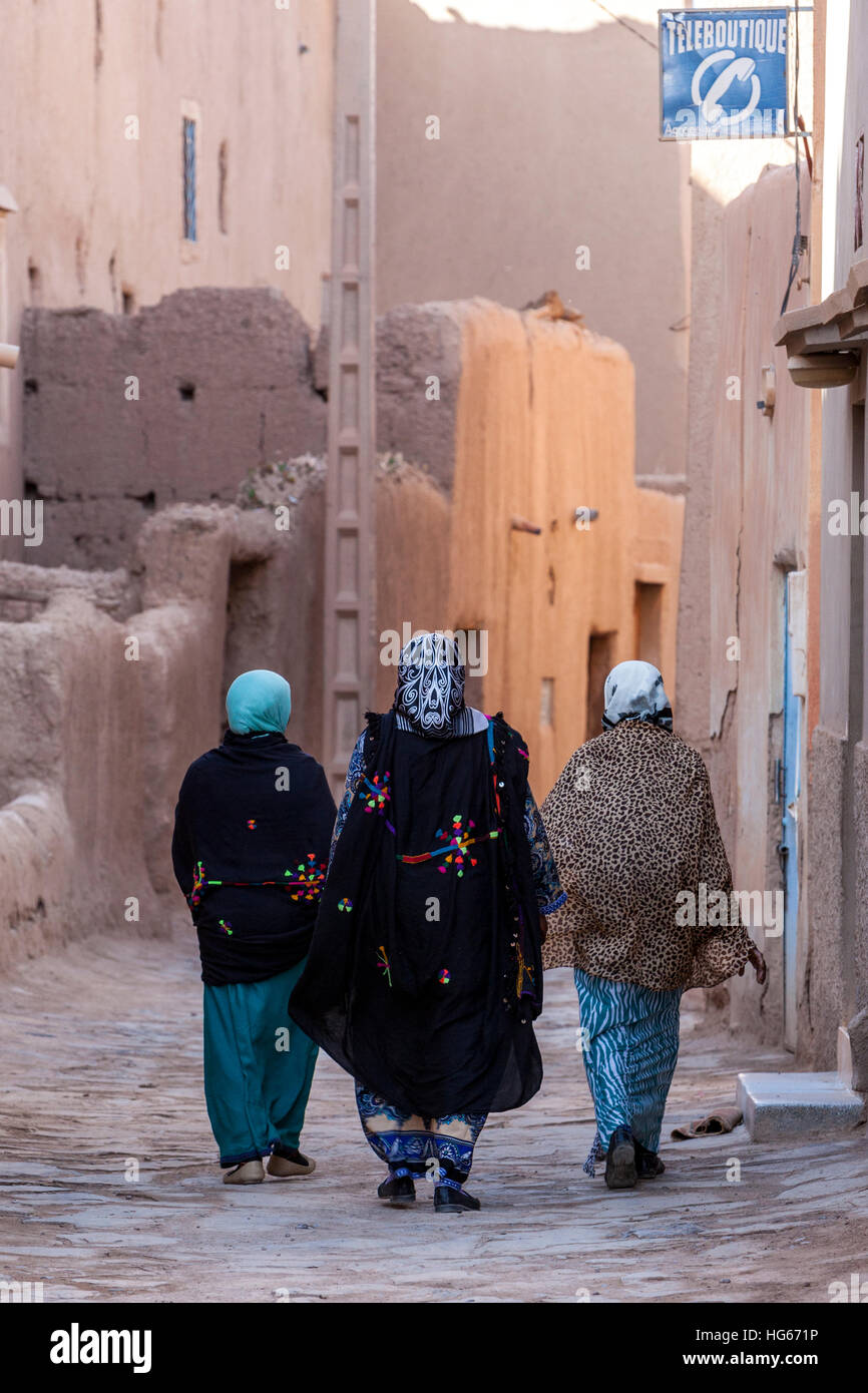 Elkhorbat, Morocco.  Street Scene.  Women Walking.  Public Telephone Store on Right ('Teleboutique') Stock Photo