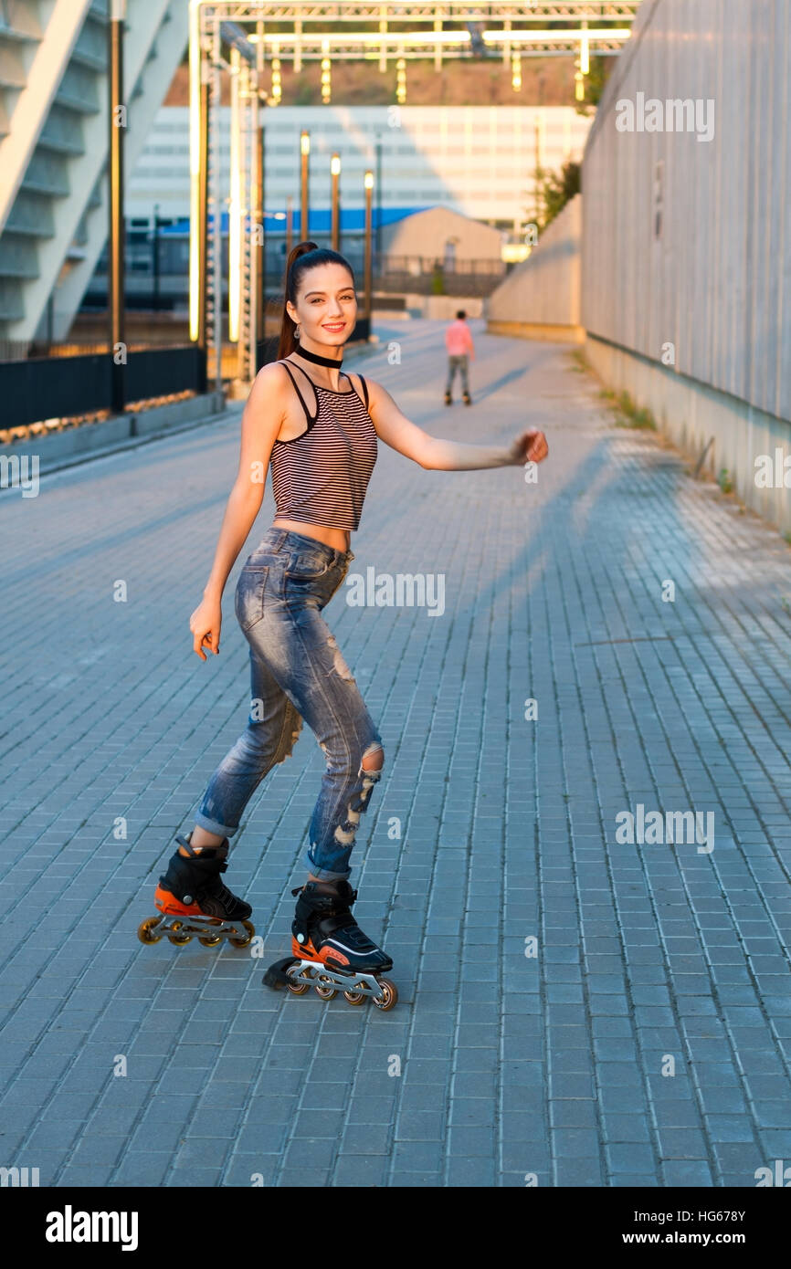 Woman rollerblading and smiling Stock Photo - Alamy