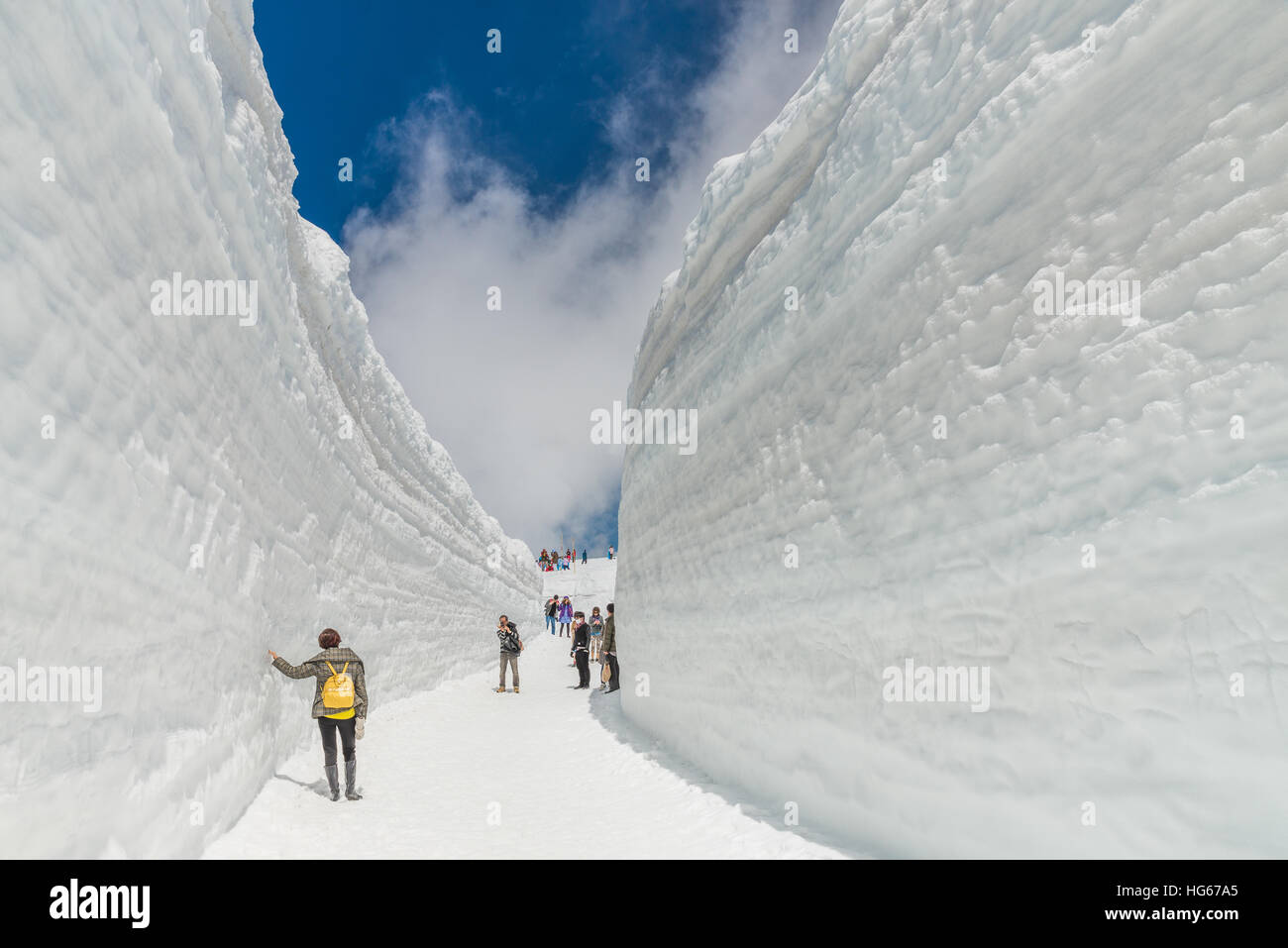 Tateyama, Japan - May 2, 2014: Unidentified tourists  visit at snow wall on Tateyama Kurobe Alpine Route,  Japanese Alps in Tateyama, Japan Stock Photo