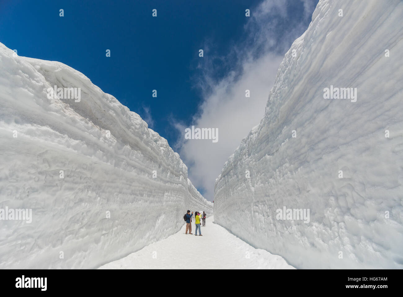 Tateyama, Japan - May 2, 2014: Unidentified tourists  visit at snow wall on Tateyama Kurobe Alpine Route,  Japanese Alps in Tateyama, Japan Stock Photo