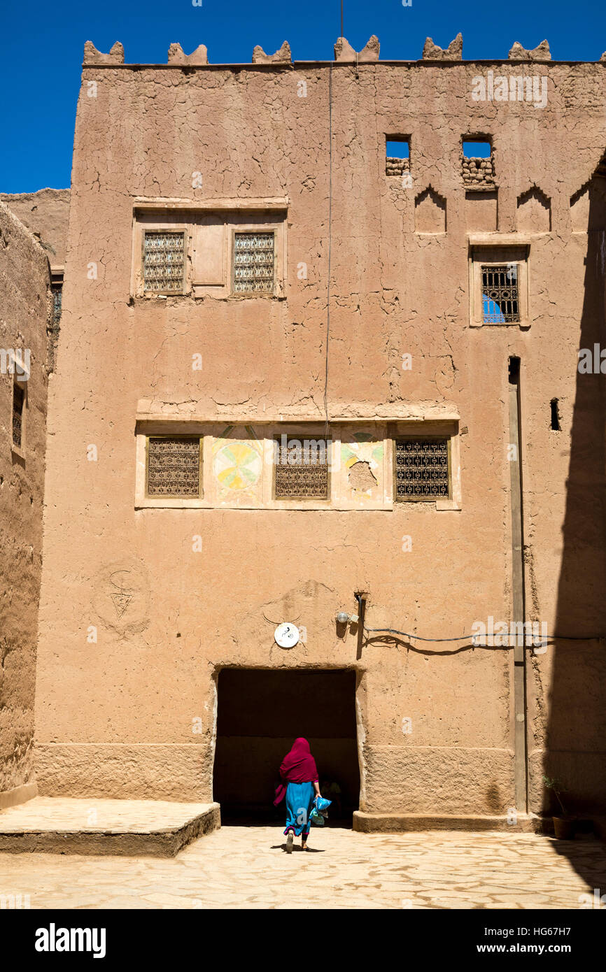 Ksar Elkhorbat, Morocco.  Amazigh Berber Woman Entering the Casbah. Stock Photo