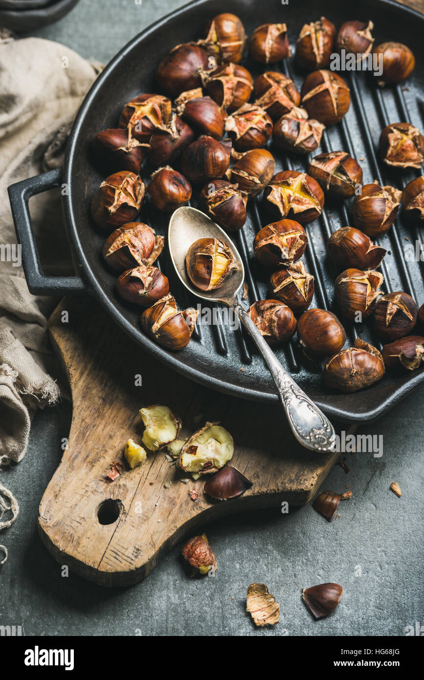 Roasted chestnut in frying pan on black stone background Stock Photo - Alamy