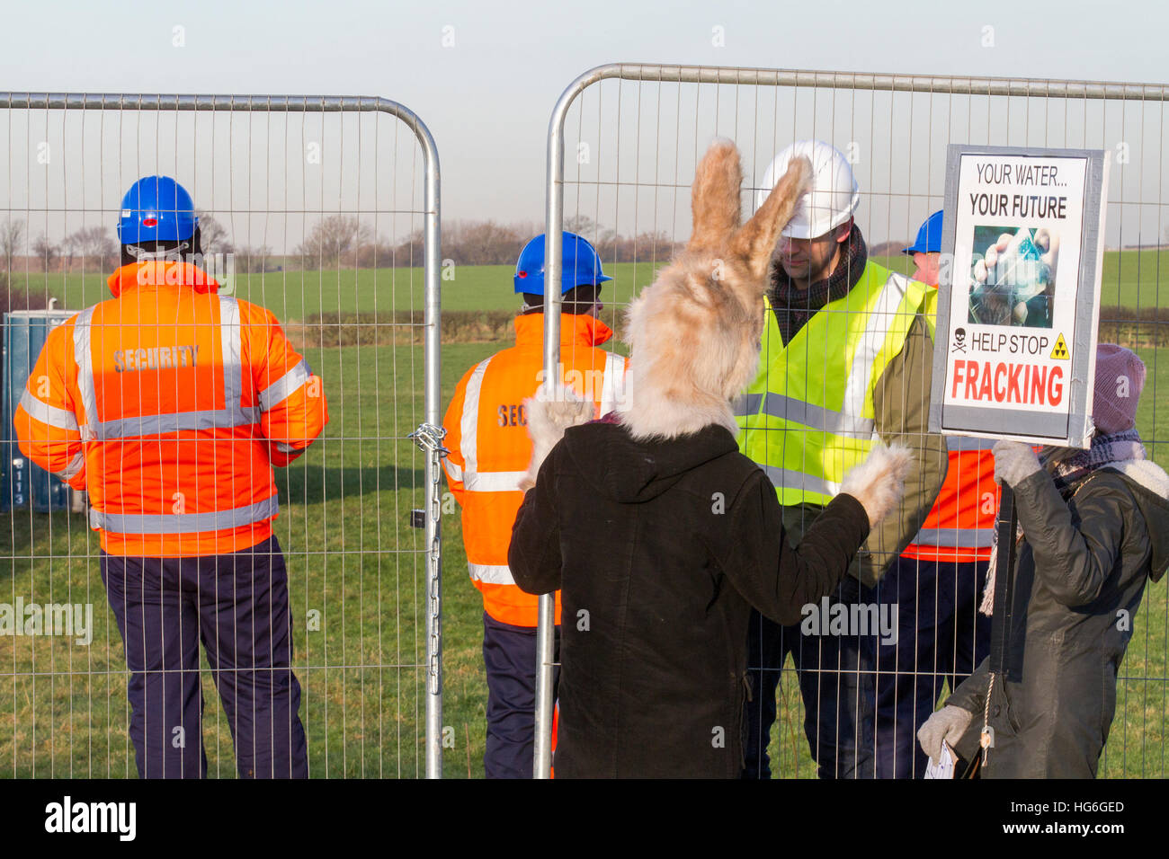 Little Plumpton, Lancashire, UK. 5th Jan 2017. 'Hop It'  Help stop fracking demonstrators protest as Security moves into the heavily protected area of Little Plumpton, a site designated for the installation of four wells for shale gas extraction by the notorious 'Fracking' process. Protesters claim this fracturing process is linked to water pollution, ill health and earthquakes. This controversial Cuadrilla 'Fracking' site was approved on appeal by Communities Secretary Sajid Javid in early December 2016, overturning Lancashire County Councils previous refusal. © Cernan Elias/Alamy Live News Stock Photo