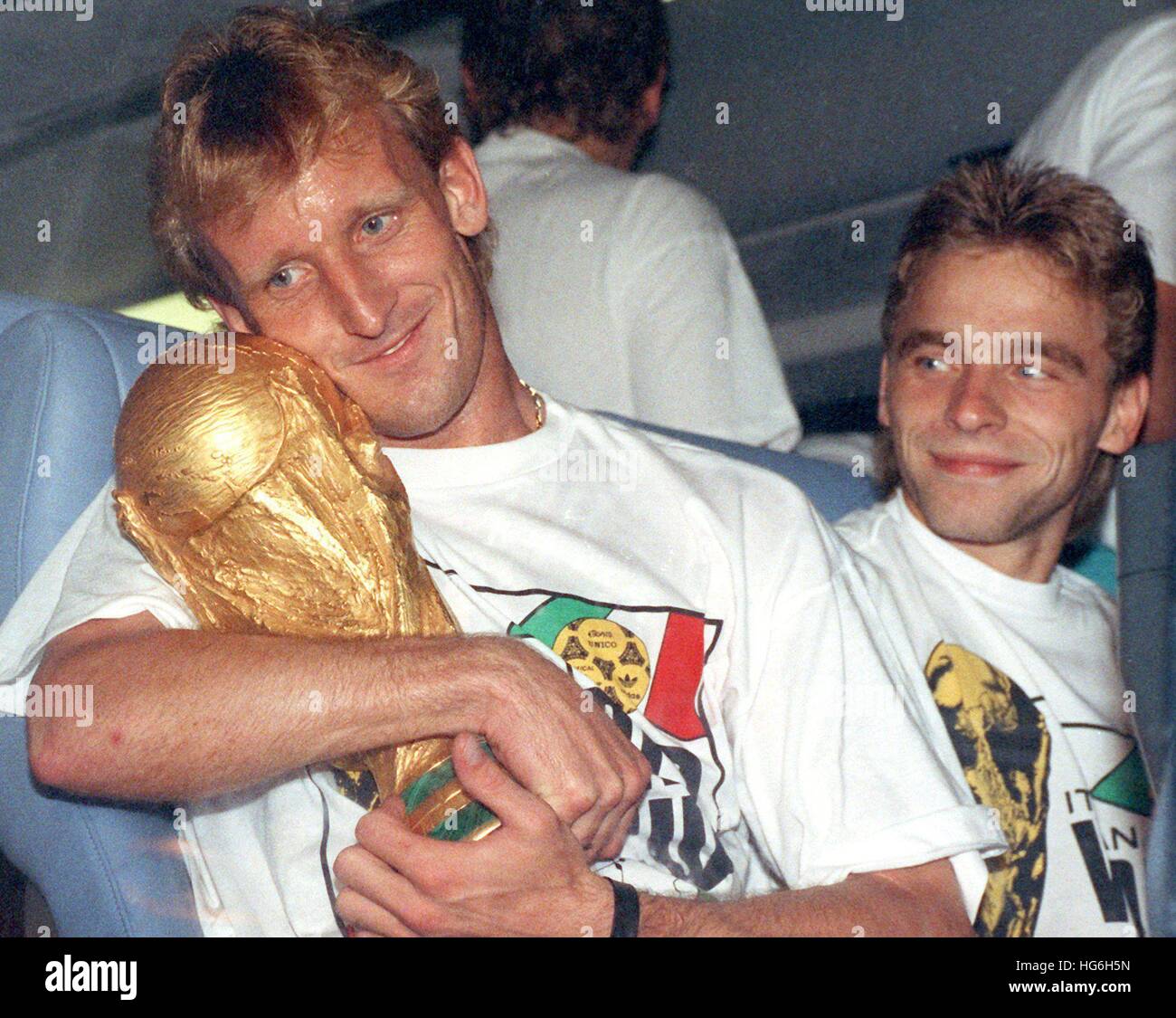 FILE - A file picture dated 09 July 1990 depicts Germany national soccer team player Andreas Brehme (L) holding the World Cup as his teammate Thomas Haessler looks on in Rome, Italy. Photo: Frank Kleefeldt/dpa Stock Photo