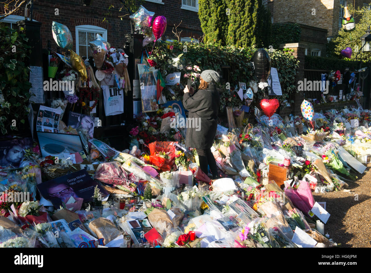 London, United Kingdom. 5th Jan, 2017. Tributes of flowers, photographs and candles are left outside the home of pop music icon George Michael in The Grove, Highgate in London, England. Singer George Michael died on Christmas day in his country home in Oxfordshire at the age of 53 on December 25. Credit: Michael Tubi/Alamy Live News Stock Photo