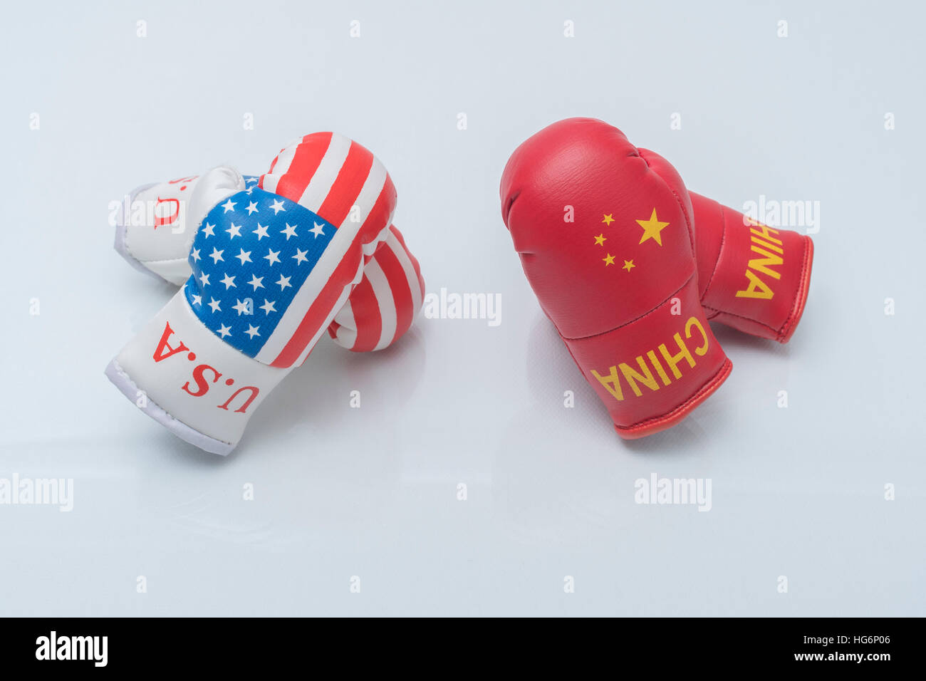 Mini US Stars & Stripes boxing gloves - metaphor for concept of US-Chinese tensions, US-China trade war, tariff war, standoff, the gloves are off. Stock Photo