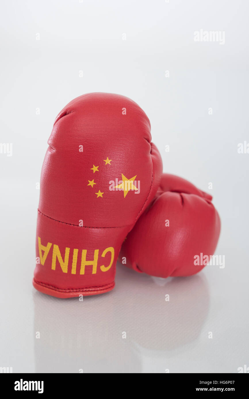 Mini Chinese boxing gloves - as visual metaphor for concept of US-Chinese tensions, US China trade war, antagonism, standoff. Stock Photo