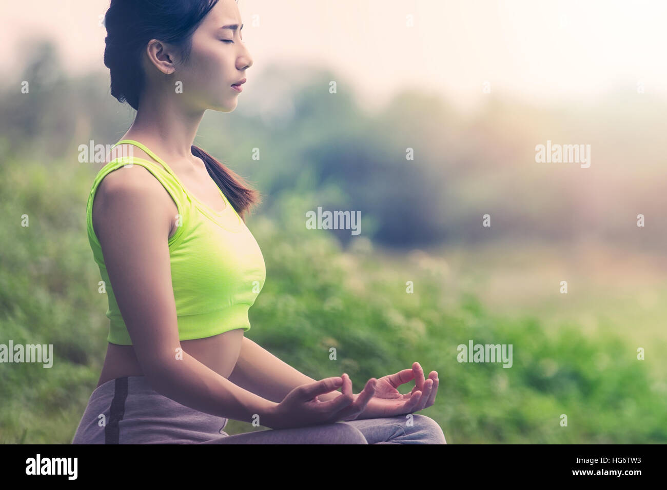 Closeup of Beautiful Asian women doing yoga in park Stock Photo - Alamy