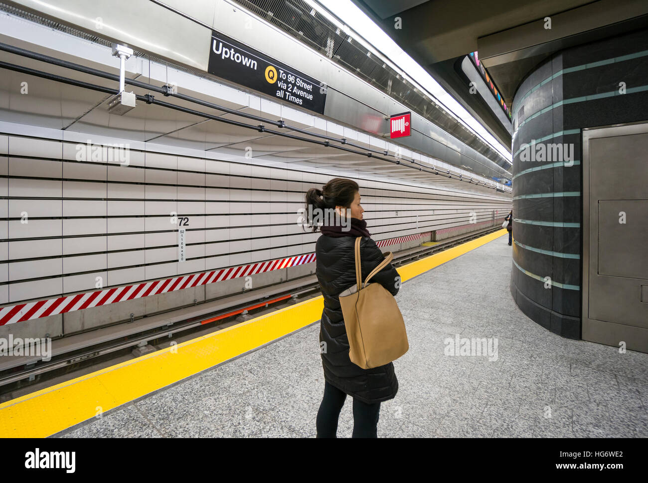 An Asian woman waiting for an Uptown train at 72nd Street Station of ...