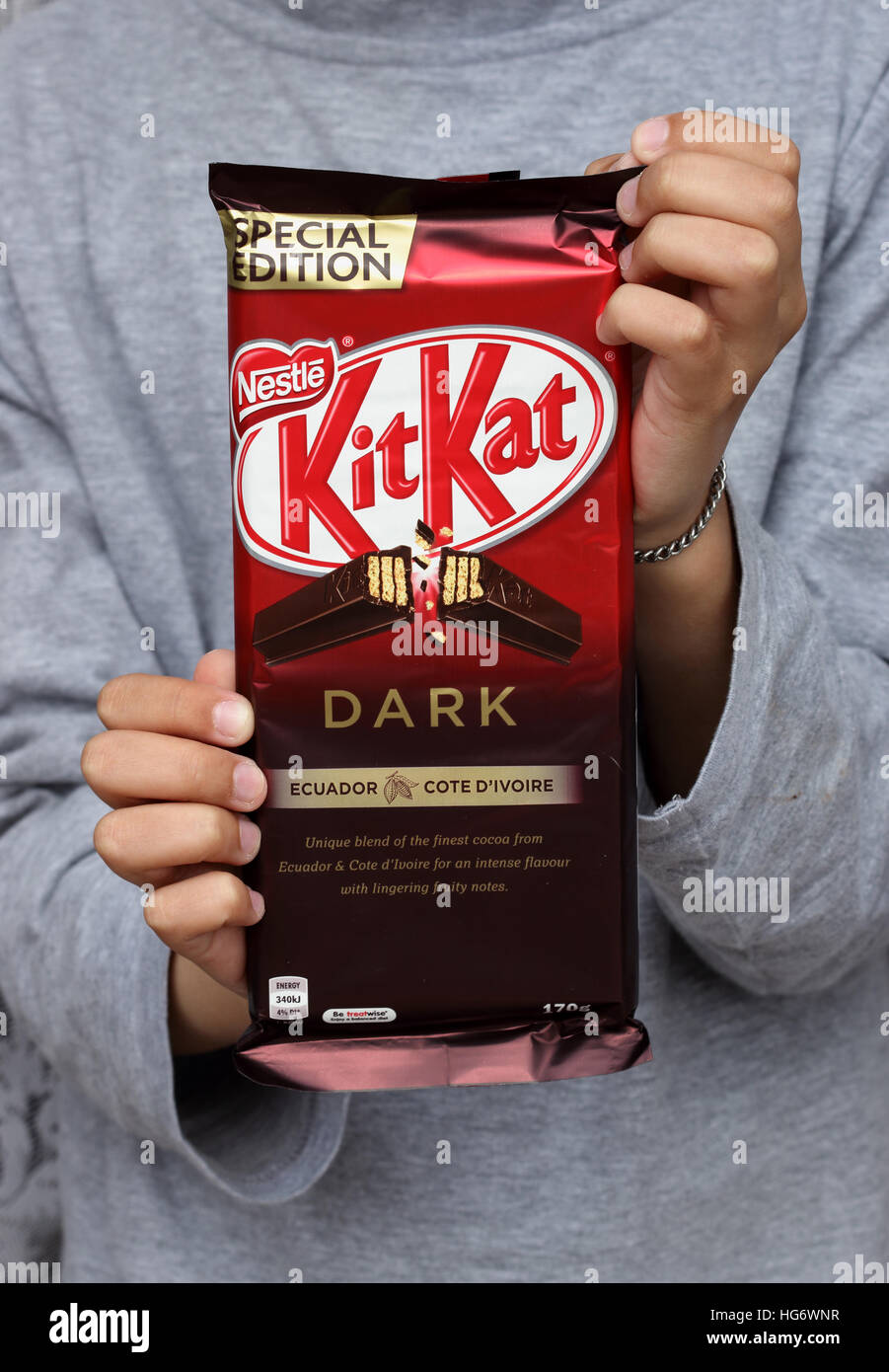 Hand holding Australian Kit Kat dark chocolate Stock Photo