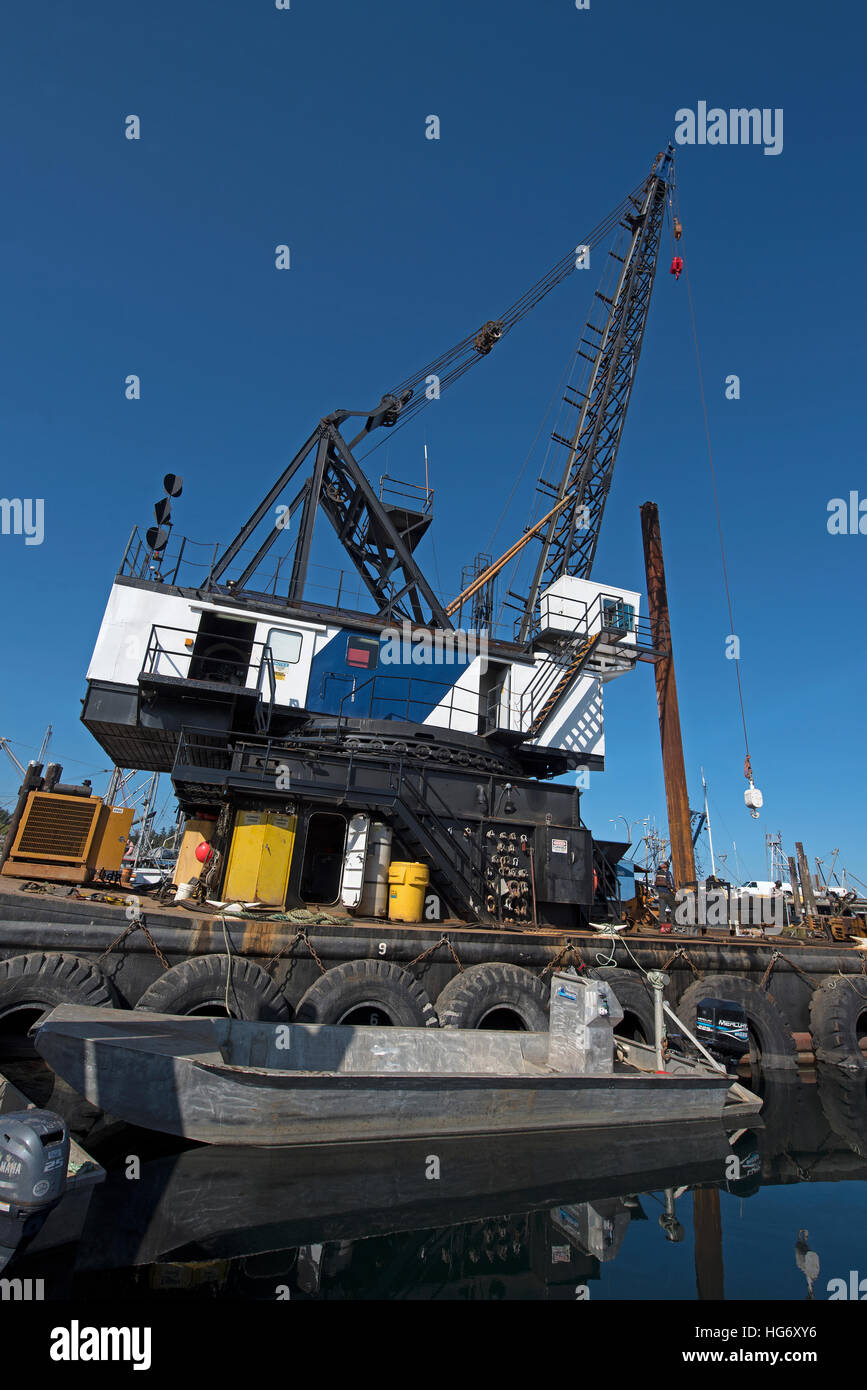 Pile driving crane HM floating debris barge working in French creek harbour, Vancouver