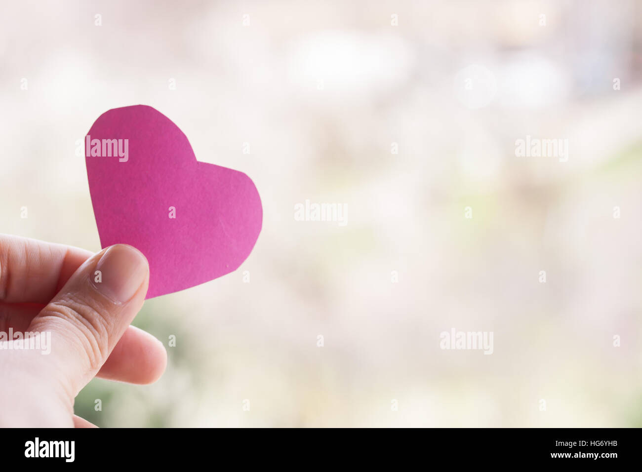 hand holding pink paper heart Stock Photo - Alamy