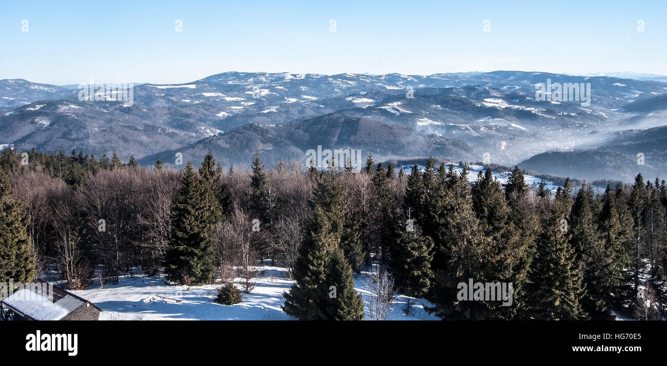 panorama of Beskid Slaski mountain range from view tower on Velka Cantoryje hill on polish-czech borders during winter day with clear sky Stock Photo