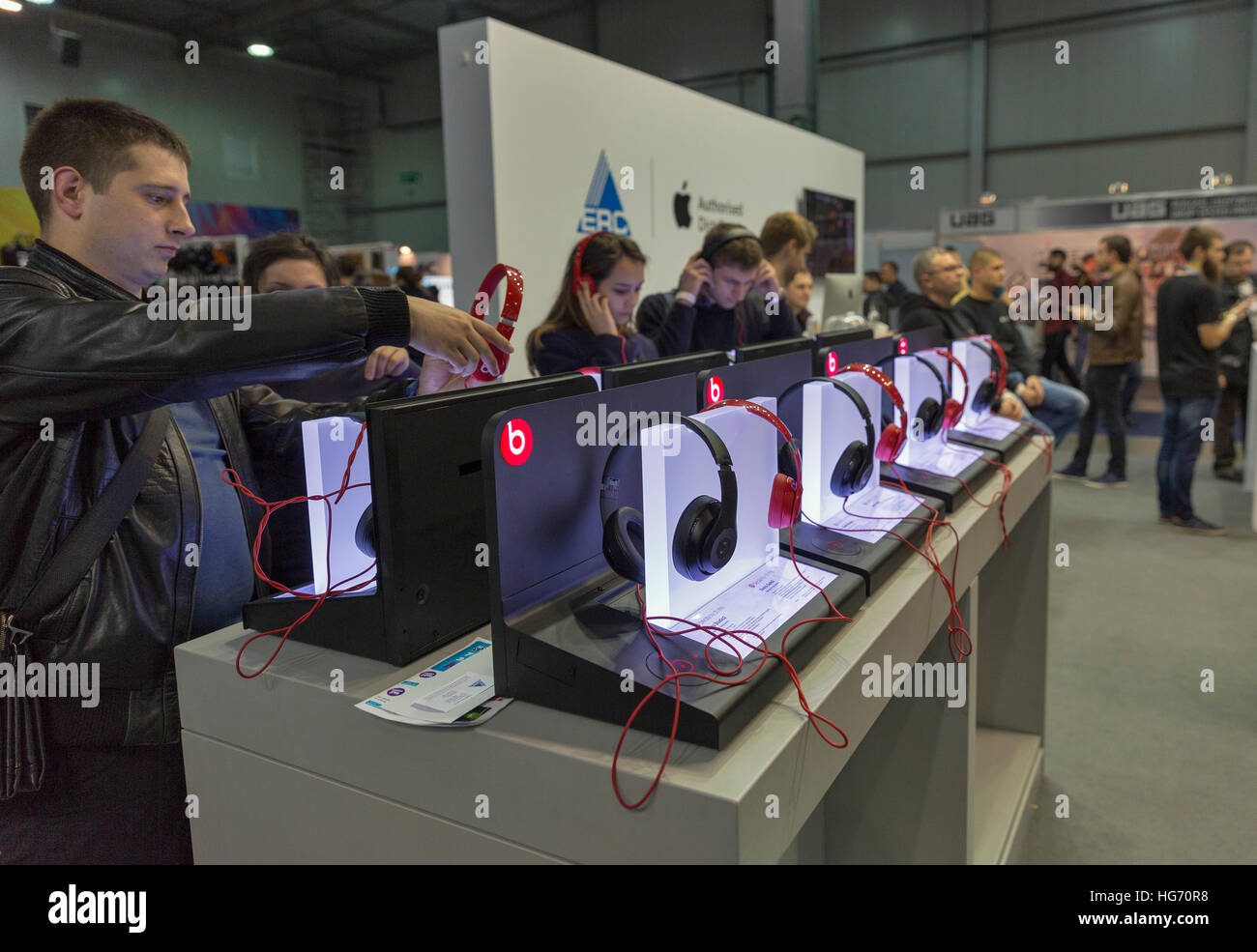 People testing Beats by Dr Dre headphones at CEE 2016, electronics trade show in KyivExpoPlaza EC. Stock Photo