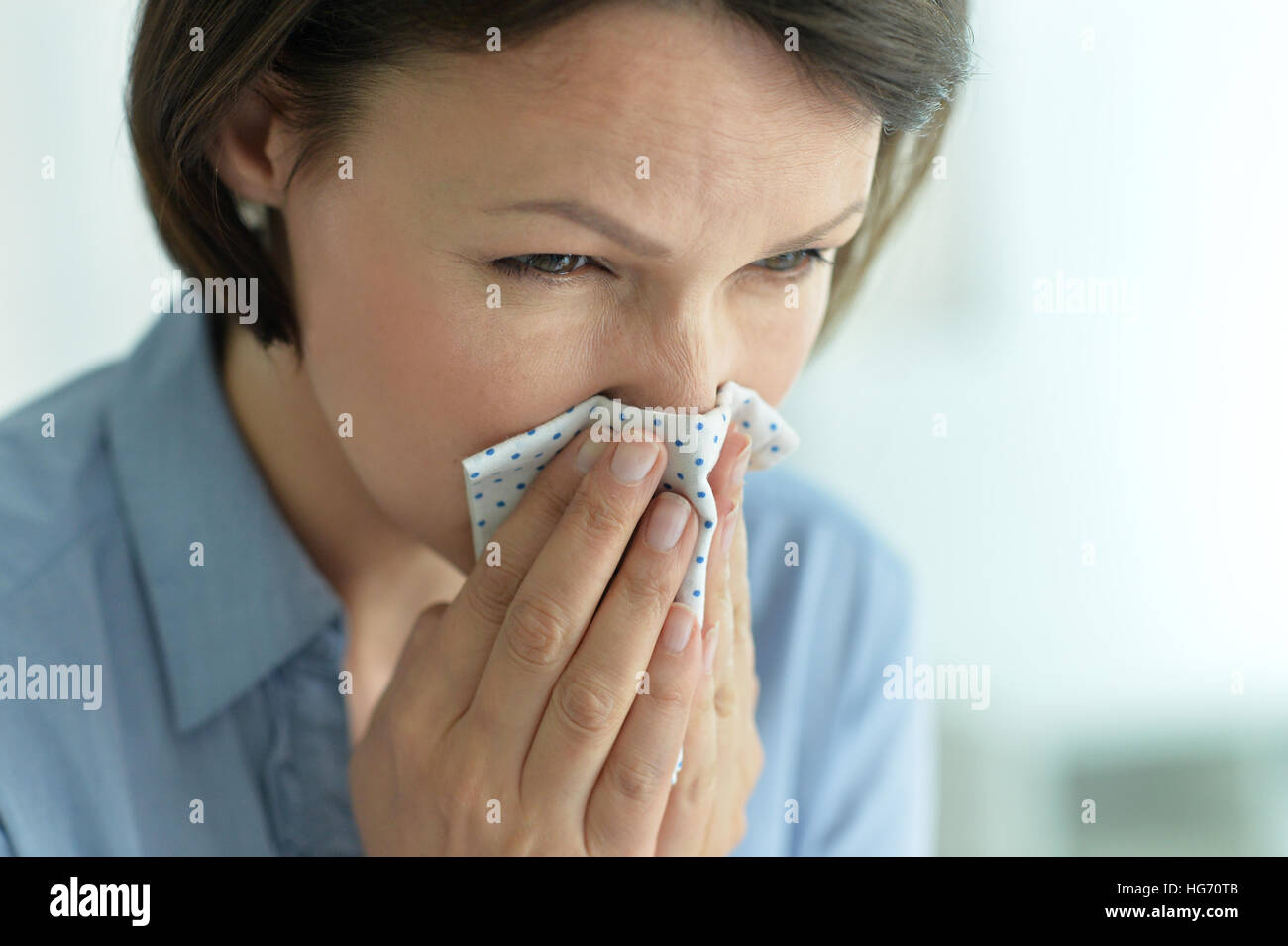 young woman sneezing Stock Photo Alamy