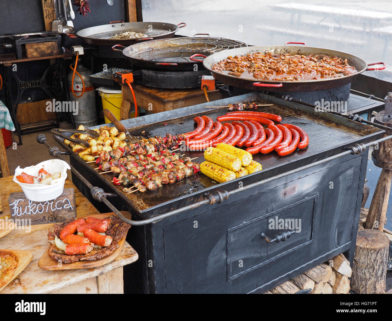 Typical Hungarian colorful street food including sausages, Shaslik, Goulash, and Kukorica (Mais). Stock Photo