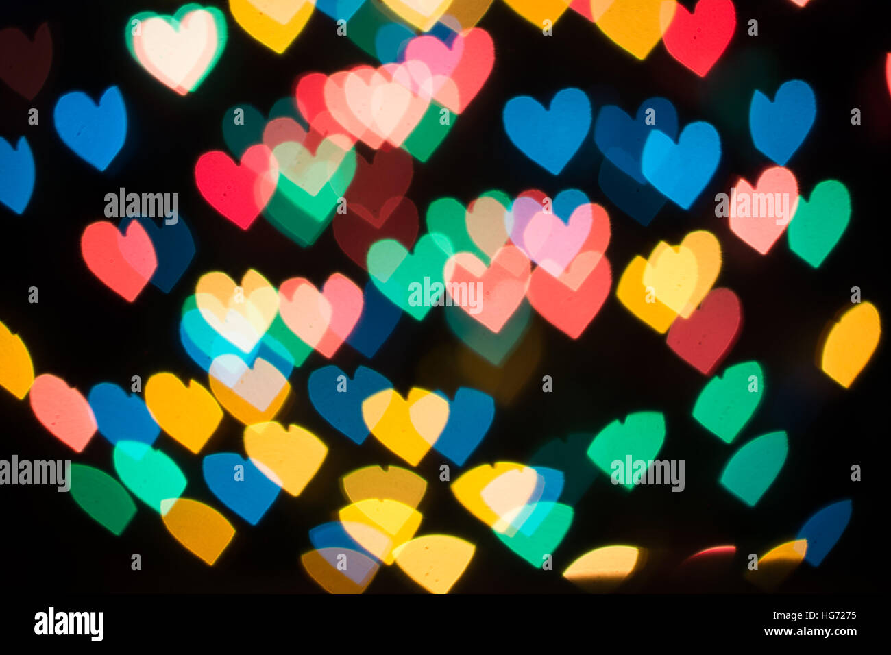 Heart shaped bokeh spread on dark background Stock Photo