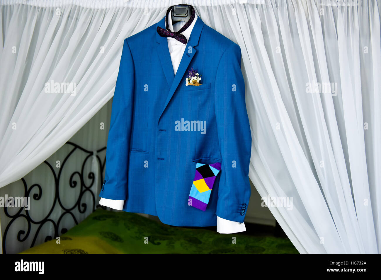 Groom suit hanging in the house in daylight Stock Photo