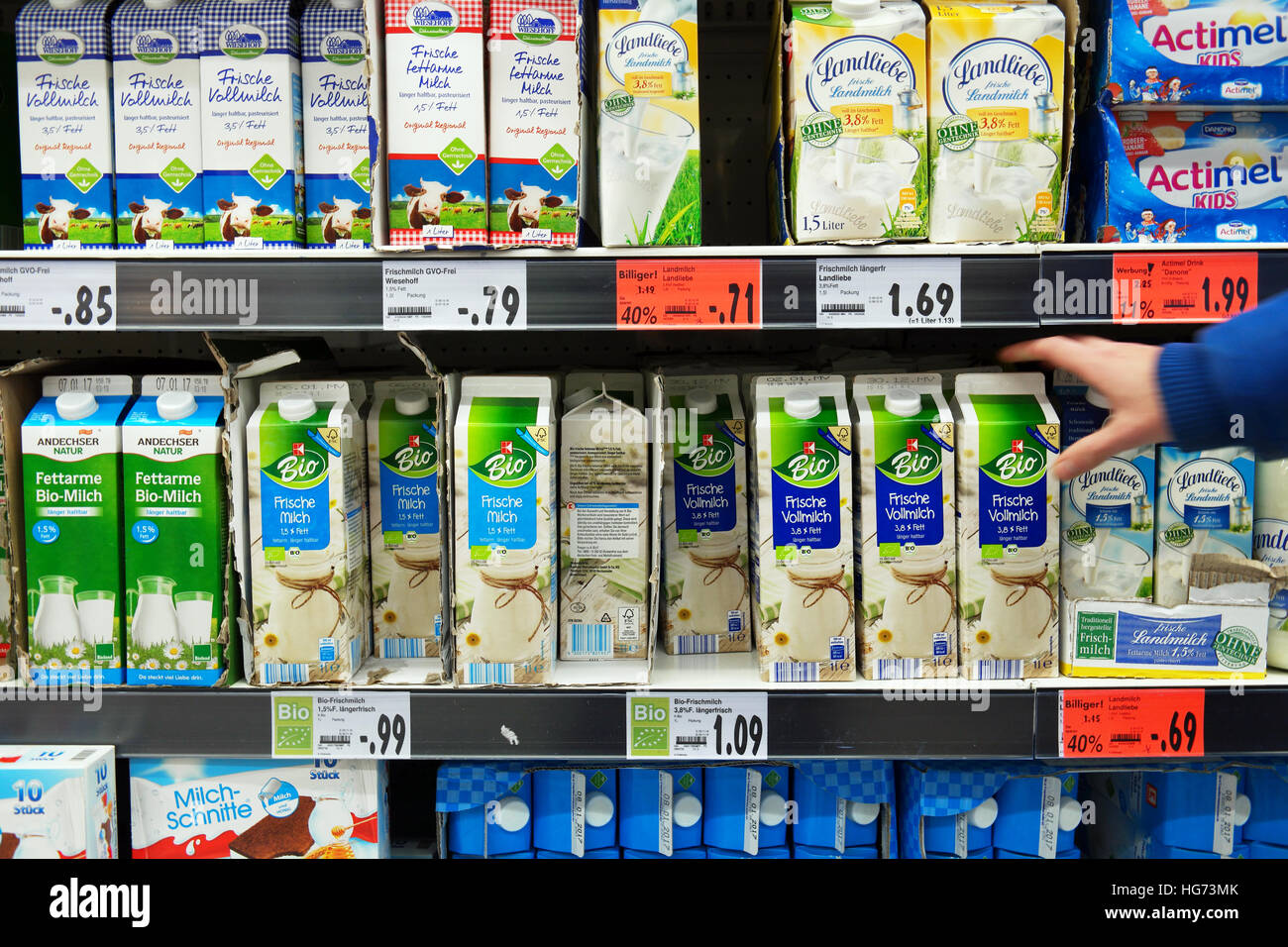 Customer takes bio milk packing in Supermarket. Stock Photo