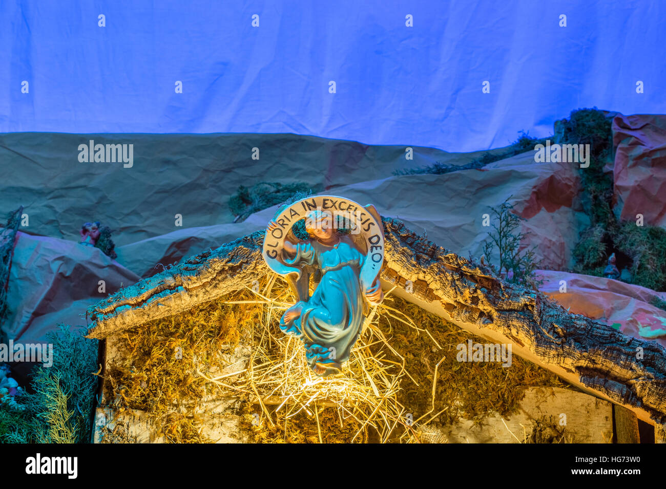 Angel from Christmas nativity scene with Latin sentence meaning glory