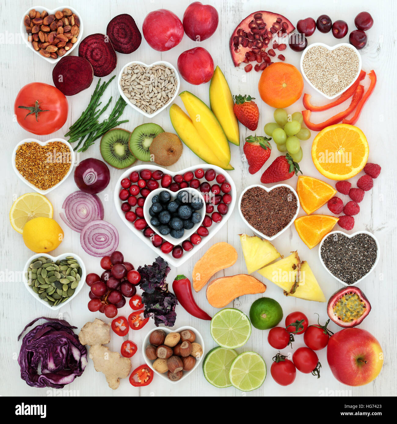 Paleolithic diet food of fresh fruit and vegetables, nuts and seeds on distressed white wood