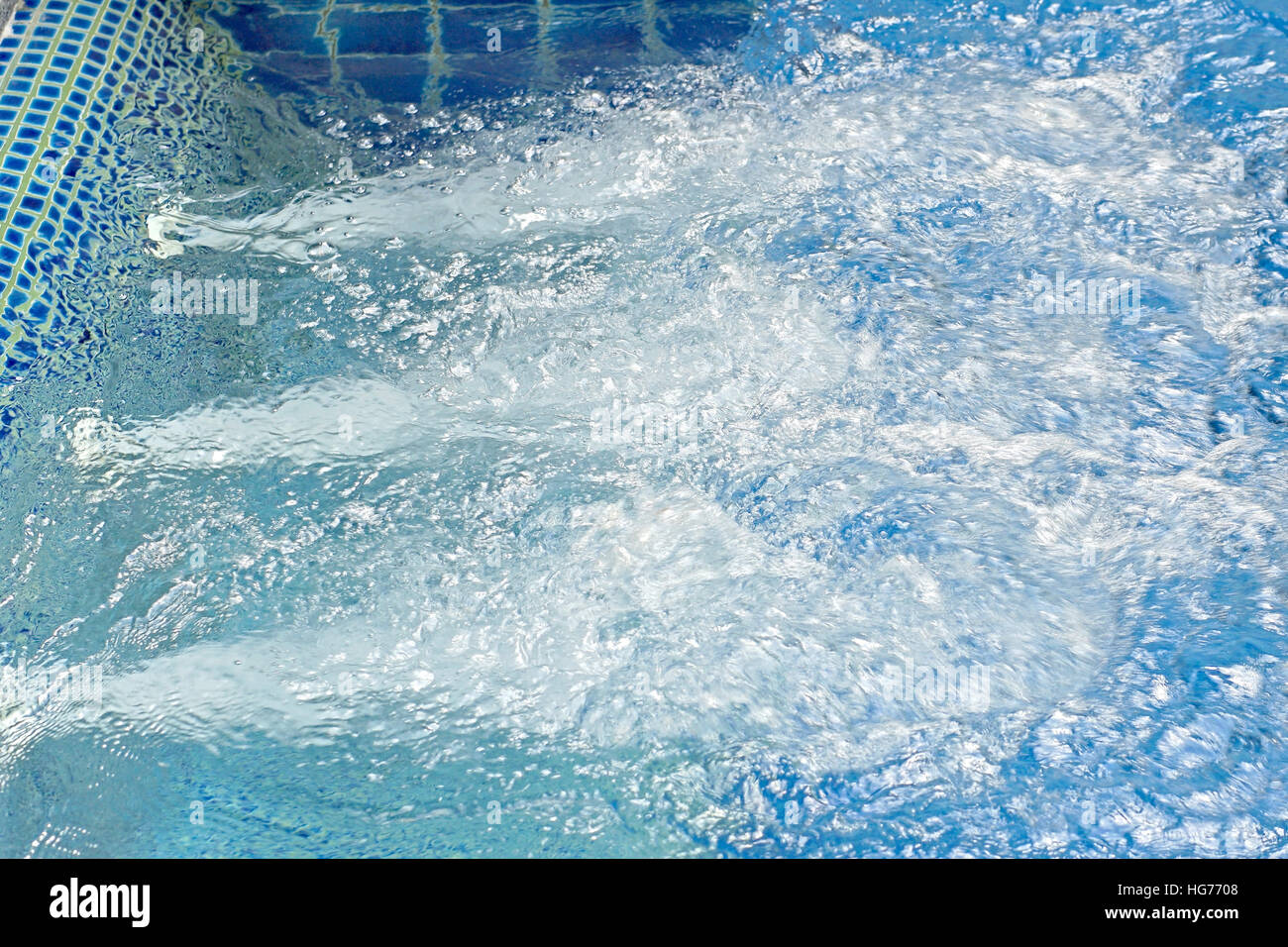 blue ripped water in jacuzzi pool, spa massage background Stock Photo