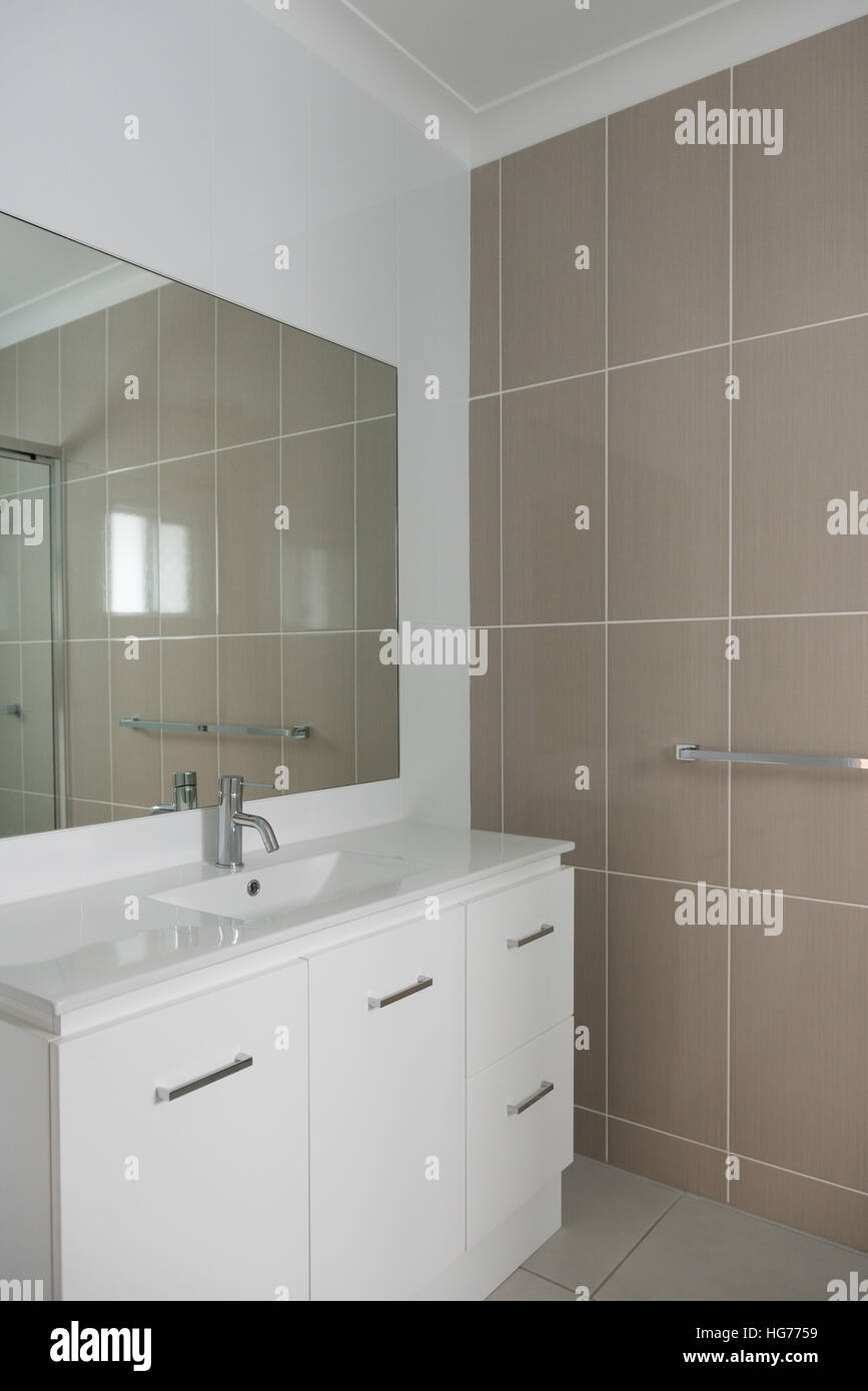 Contemporary style bathroom with vanity and tiled walls Stock Photo
