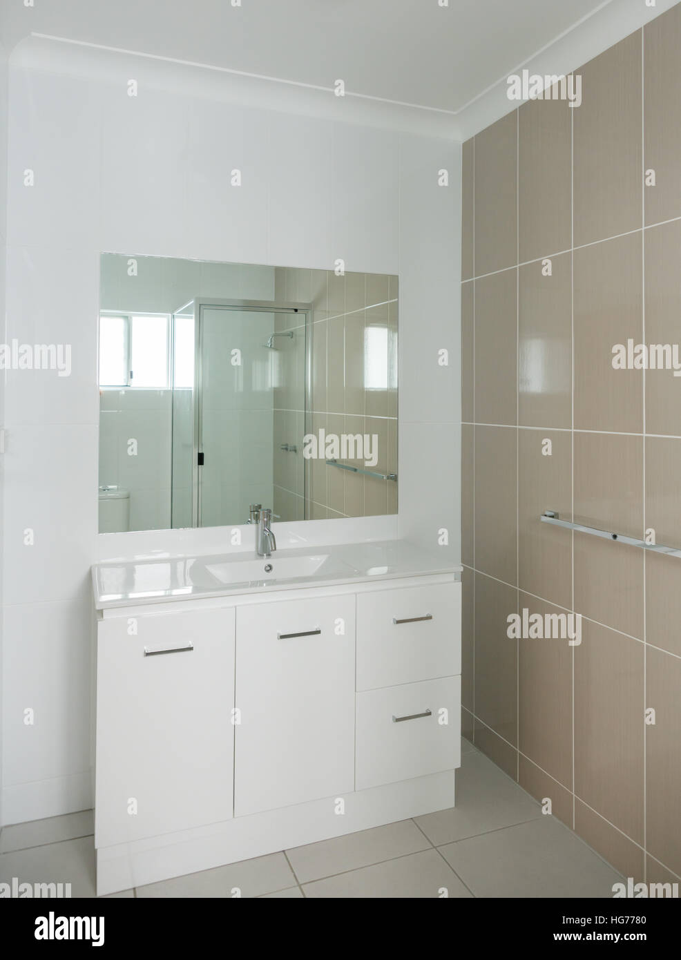 New modern bathroom with vanity unit and tiled walls Stock Photo - Alamy