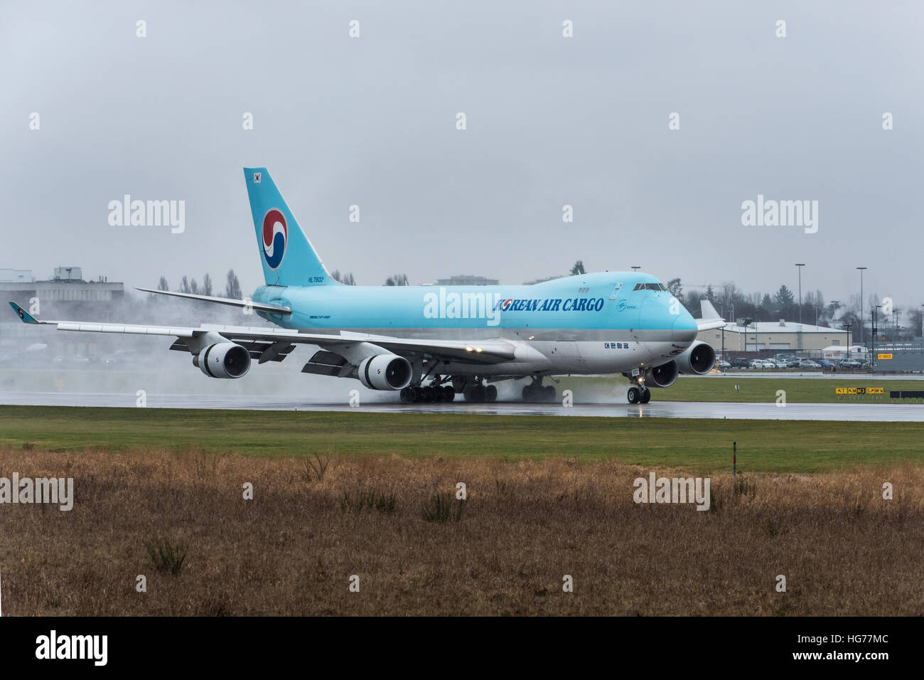 Korean Air Cargo wide body Boeing 747-400F making a landing on a wet runway at Vancouver International Airport. Stock Photo