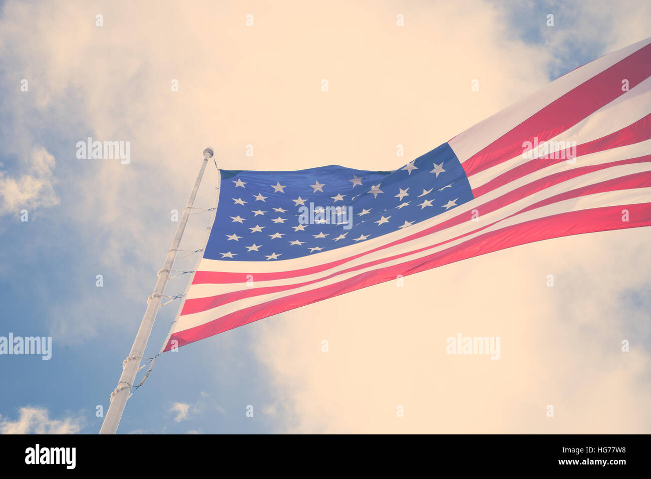 An American Flag blows in the wind with a beautiful sky Stock Photo
