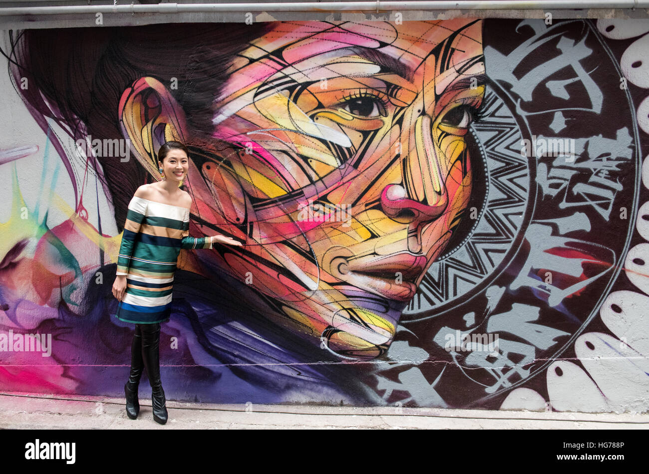 Wall painting by Parisian street artist Alexandre Monteiro aka Hopare of Hong Kong actress and canto pop star Niki Chow (pictured) 'Walls of Change' s Stock Photo