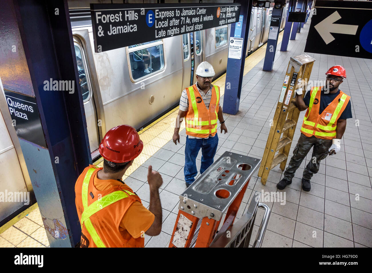 New York City,NY NYC subway,MTA,train,Queens Plaza,station,MTA worker,ladder,maintenance crew,Asian Black African Africans,adult,adults,man men male,s Stock Photo