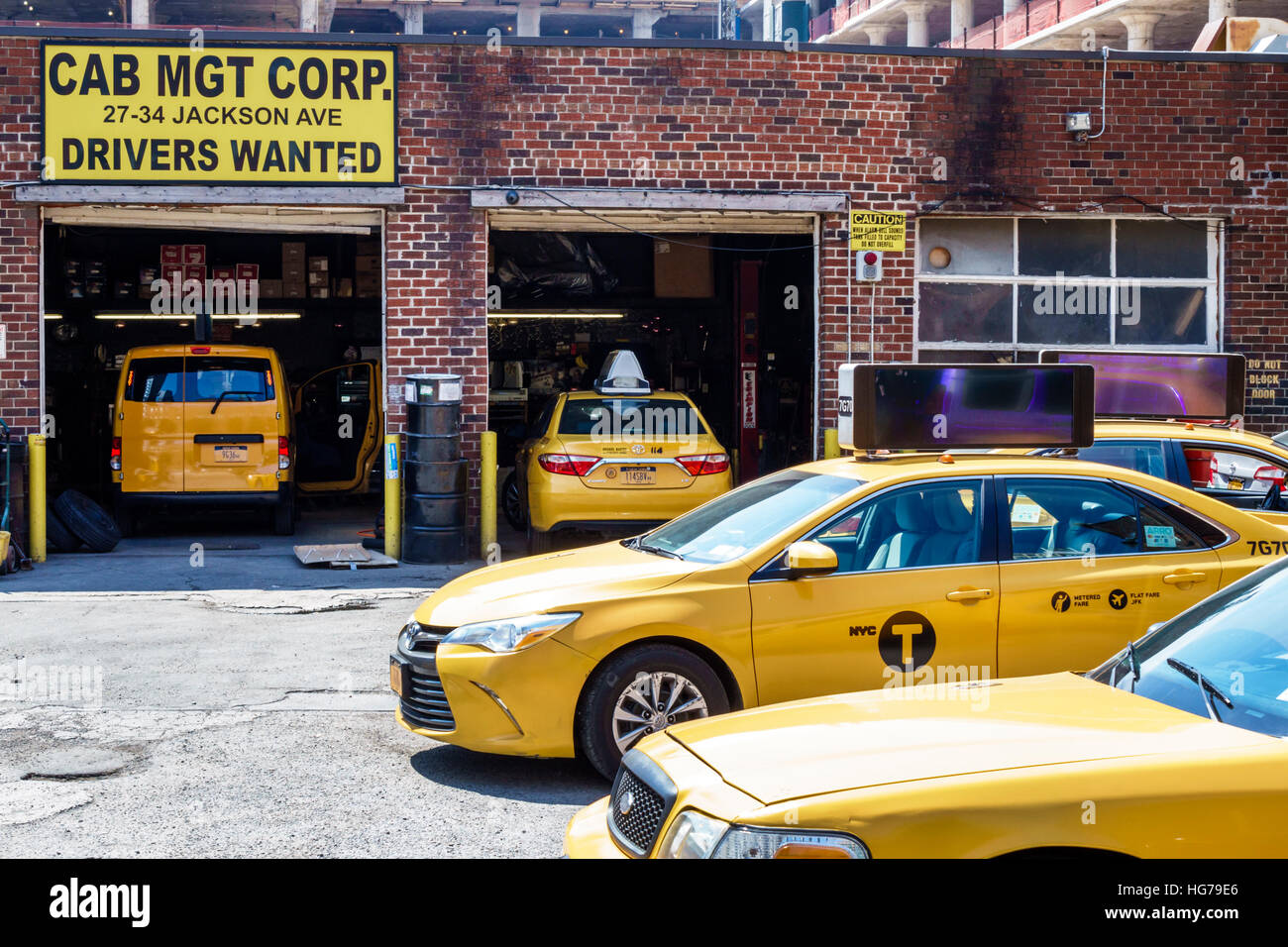 New York City,NY NYC Queens,Long Island City,Cab Management Corporation,taxi,garage,yard,repair,mechanic shop,drivers wanted,sign,yellow,cab,jobs,NY16 Stock Photo