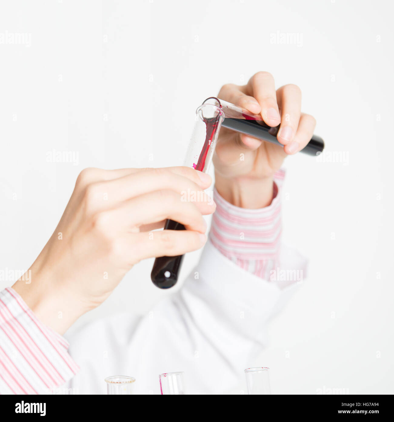 Close up hand of female scientist carrying out scientific research in a lab. Stock Photo