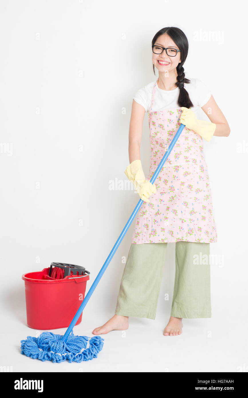 Young Asian woman mopping floor with water, home cleaning Stock Photo