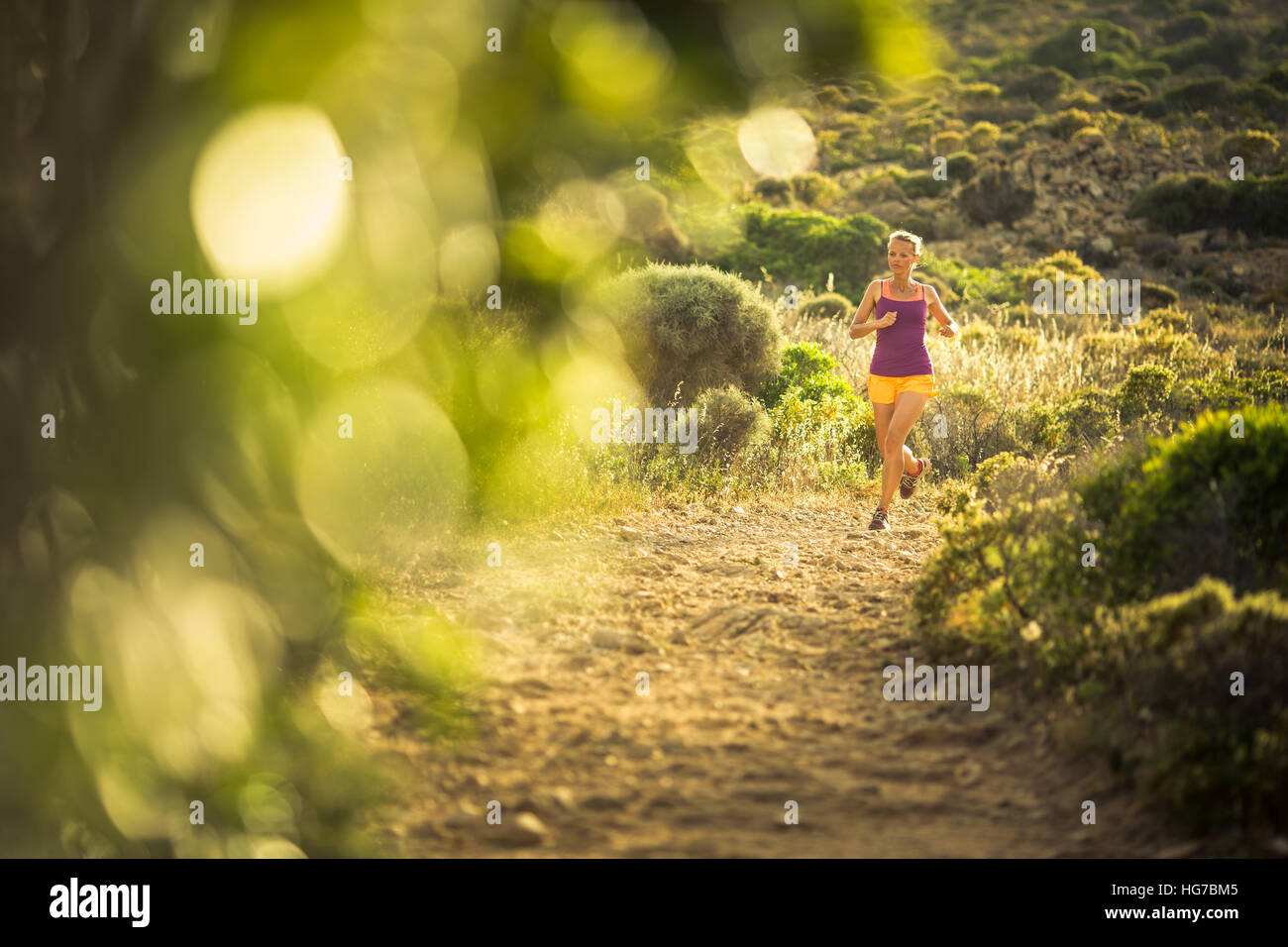 Young woman running outdoors on a lovely sunny day Stock Photo - Alamy