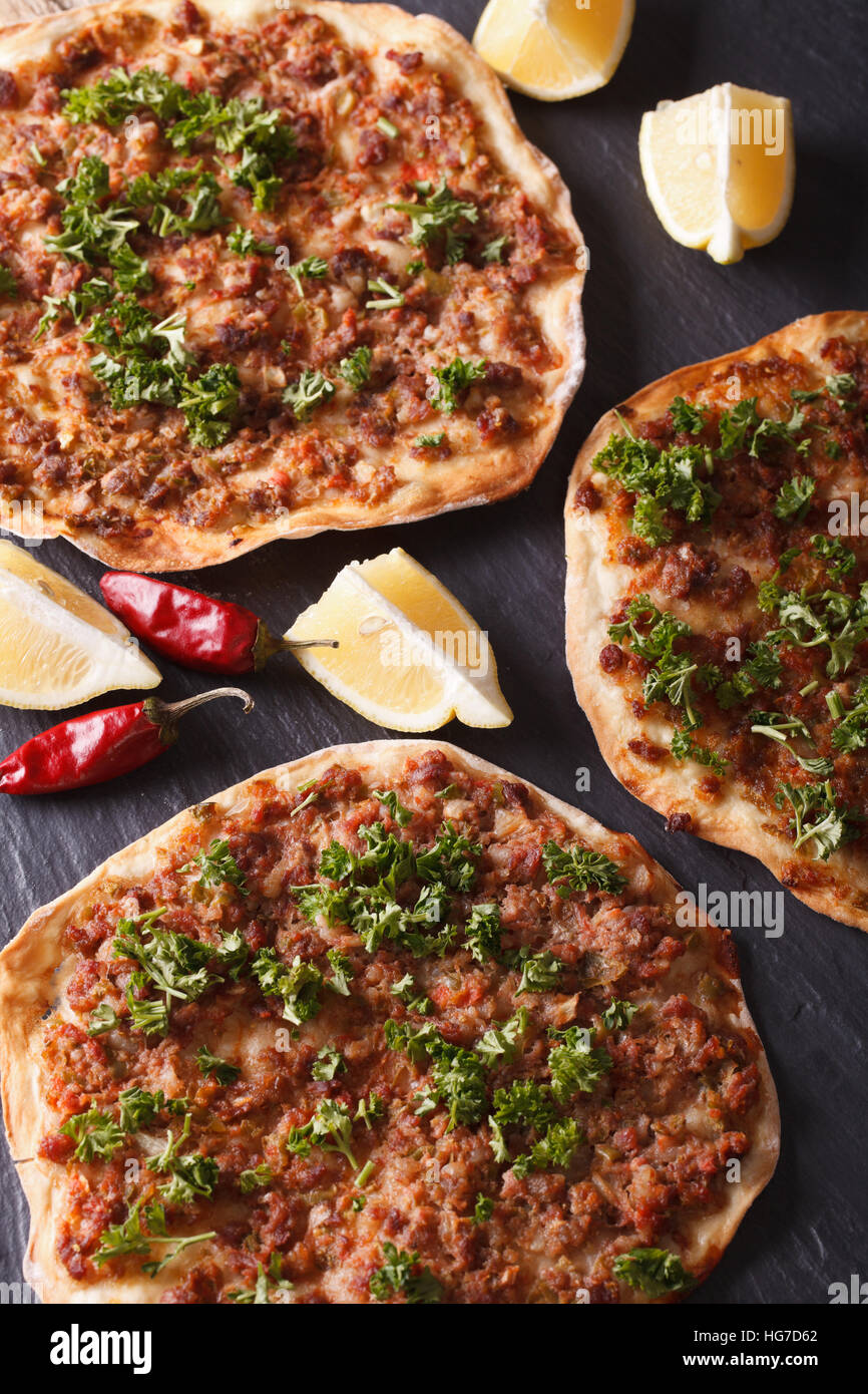 Traditional Turkish lahmacun closeup on a stone table. vertical top view Stock Photo