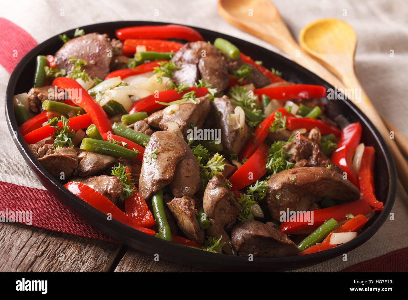 Stewed Chicken liver with onion and pepper closeup on a dish