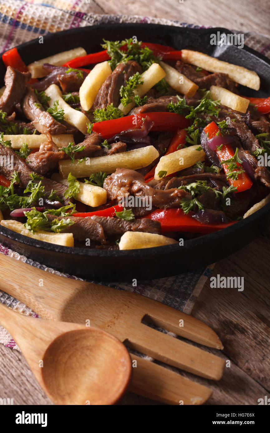 Beef with vegetables and French fries in a frying pan close-up vertical Stock Photo