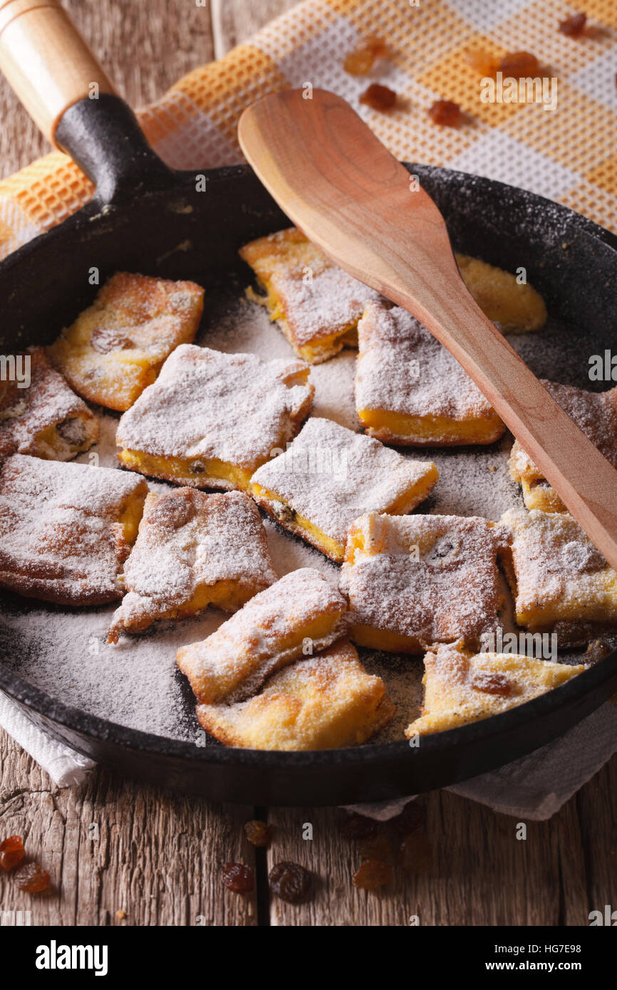 sweet omelette Kaiserschmarrn with raisins close-up in a frying pan. vertical Stock Photo