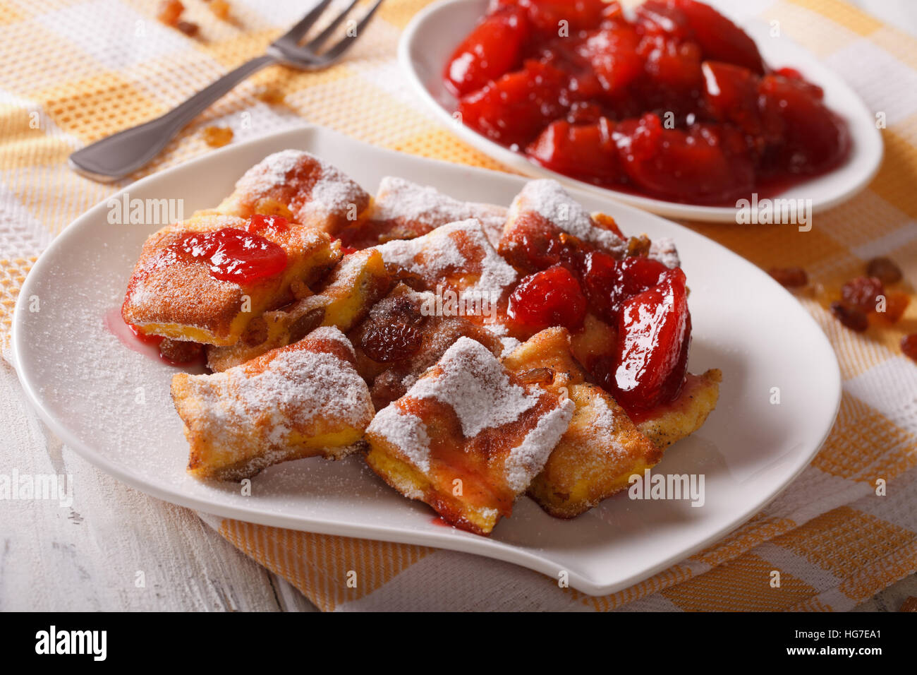 Austrian omelette Kaiserschmarrn with plum sauce close-up on a plate. horizontal Stock Photo