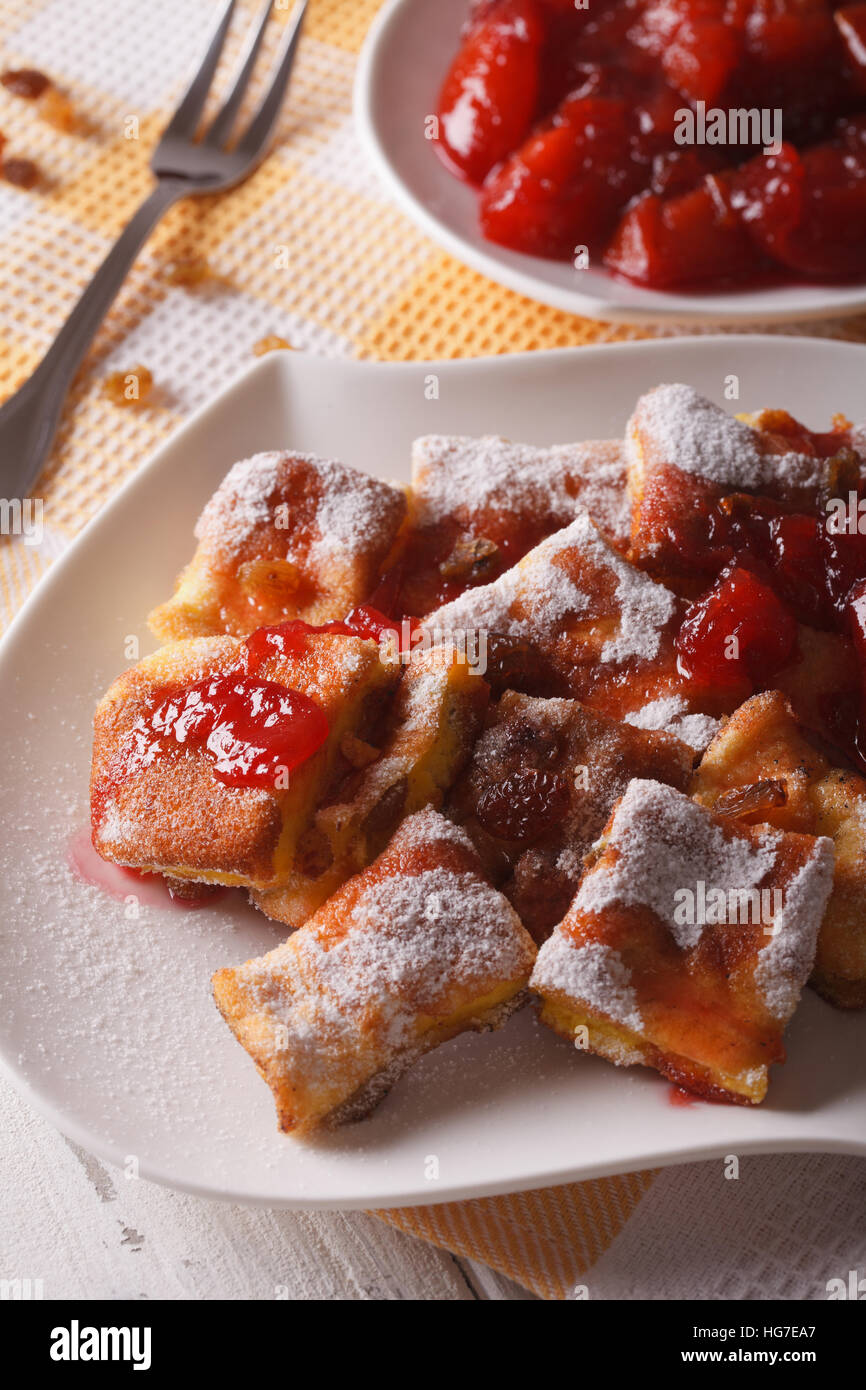 Austrian dessert Kaiserschmarrn with plum sauce close-up on a plate. Vertical Stock Photo