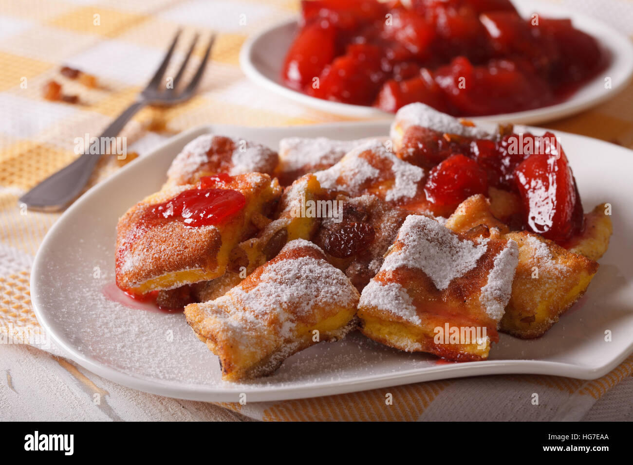 Austrian dessert Kaiserschmarrn with plum sauce close-up on a plate. horizontal Stock Photo
