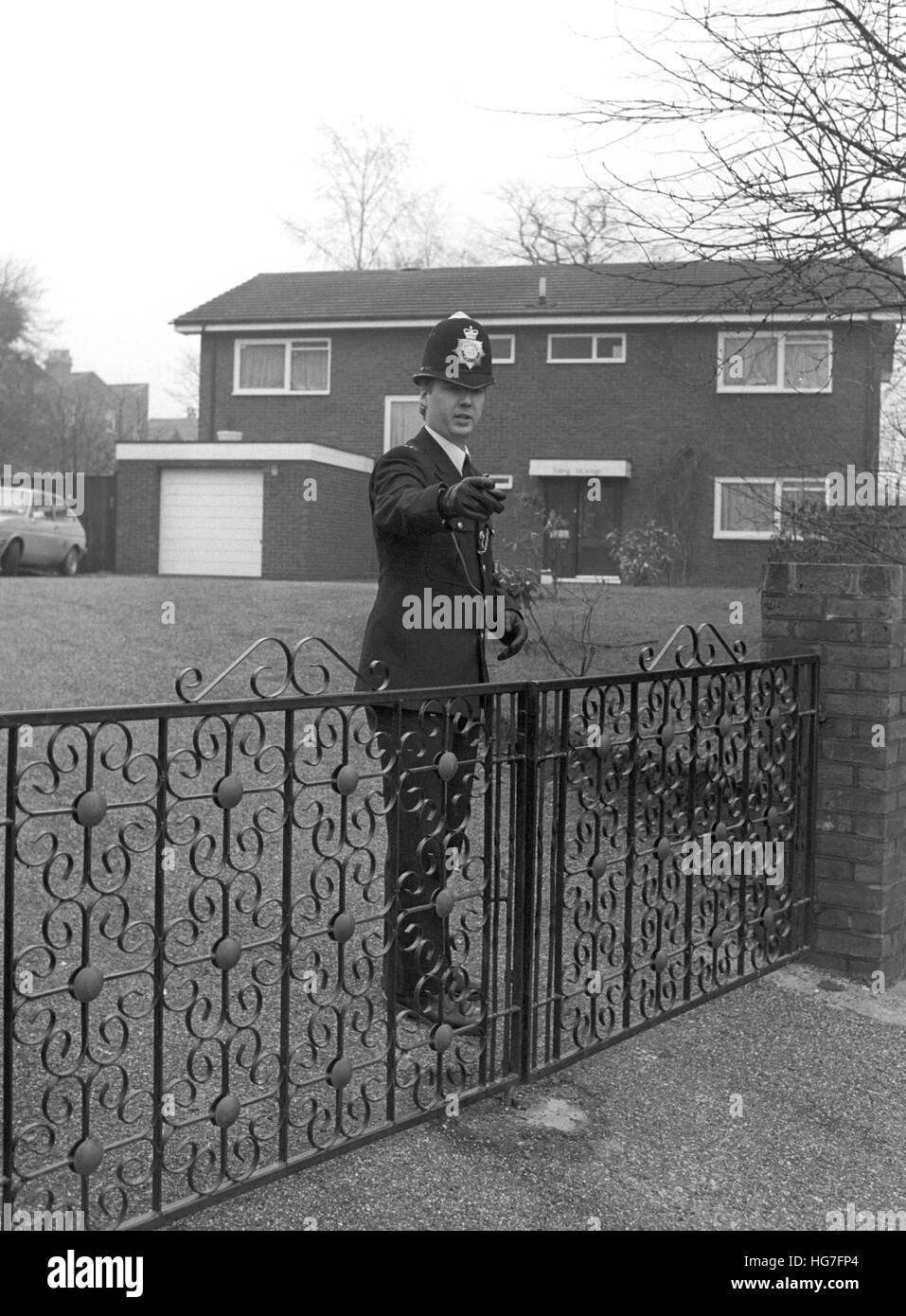 A policeman on duty today outside St Mary's Vicarage in Ealing, where three men armed with knives carried out a brutal attack on a woman, who was raped by one of the gang and sexually assaulted by the others. The vicar, Prebendary Michael Saward, 53, and David Kerr, 20, were assaulted by the gang, and property was stolen. Stock Photo