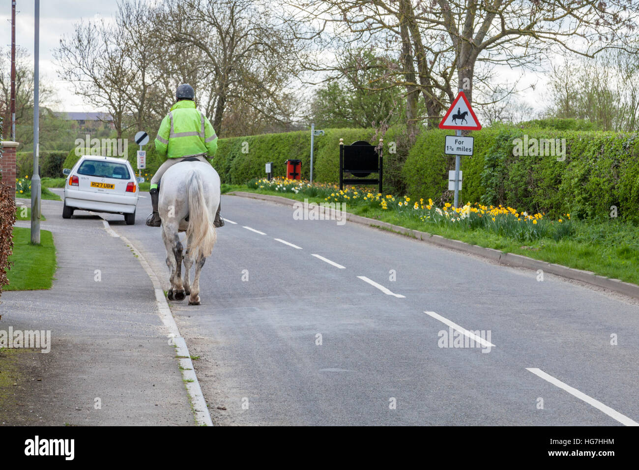 Man riding a horse on a rural road, Nottinghamshire, England, UK Stock Photo