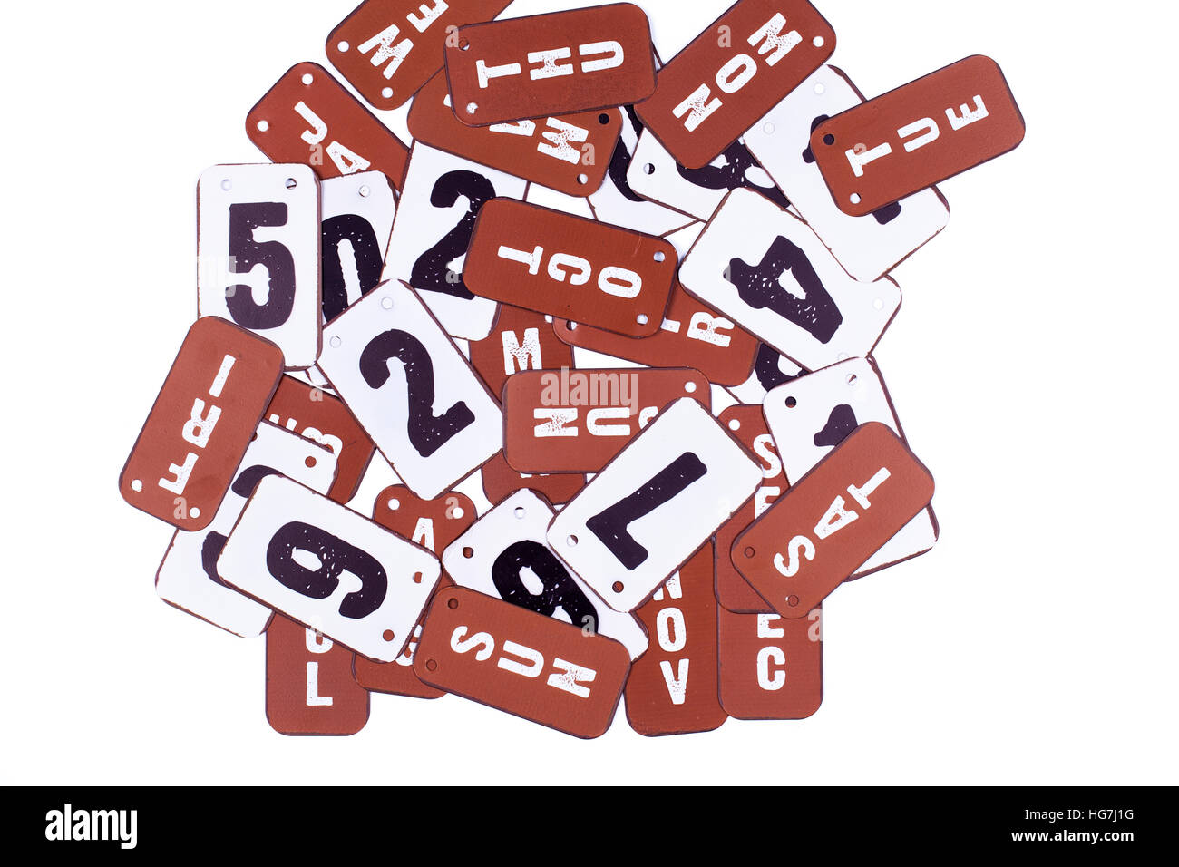 Month labels and date numbers made of red metal isolated on a white background Stock Photo