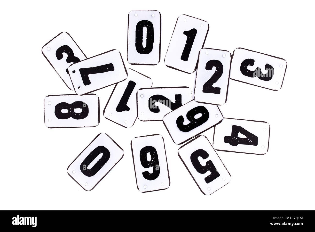 Numbers on metal plates in a pile from zero to nine isolated on white background Stock Photo