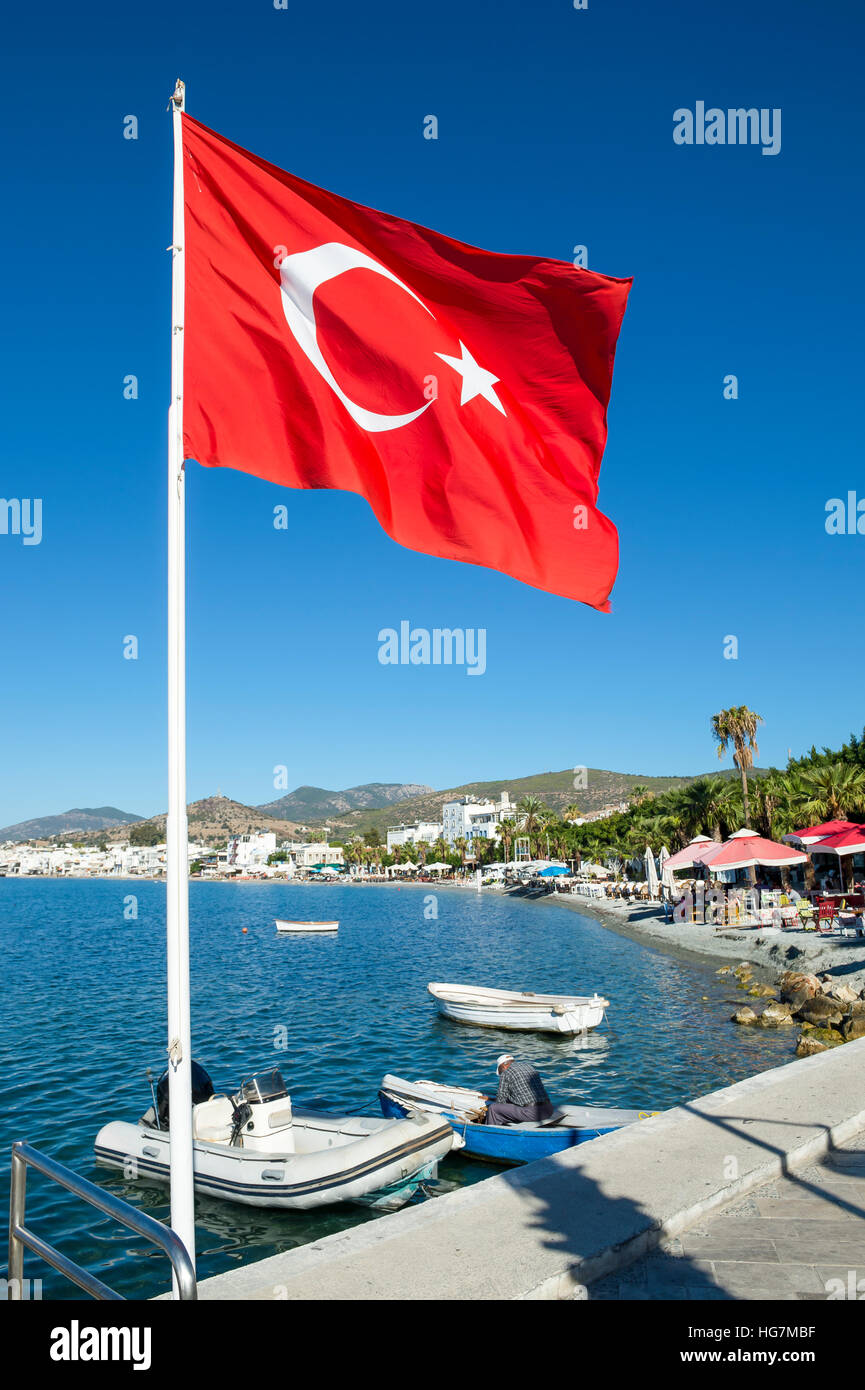 Turkish flag flying in bright blue sky in Bodrum, Turkey Stock Photo