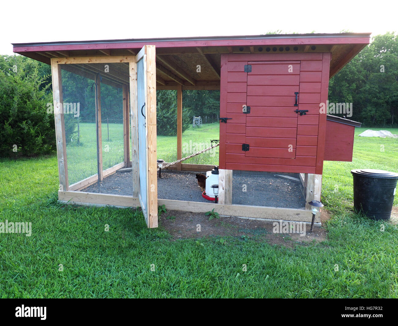 red chicken coop made of wood and screen Stock Photo